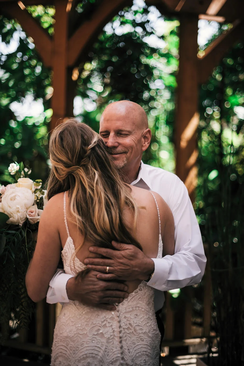 Father of the bride is overcome with joy as he hugs his daughter tightly before the Temecula wedding.