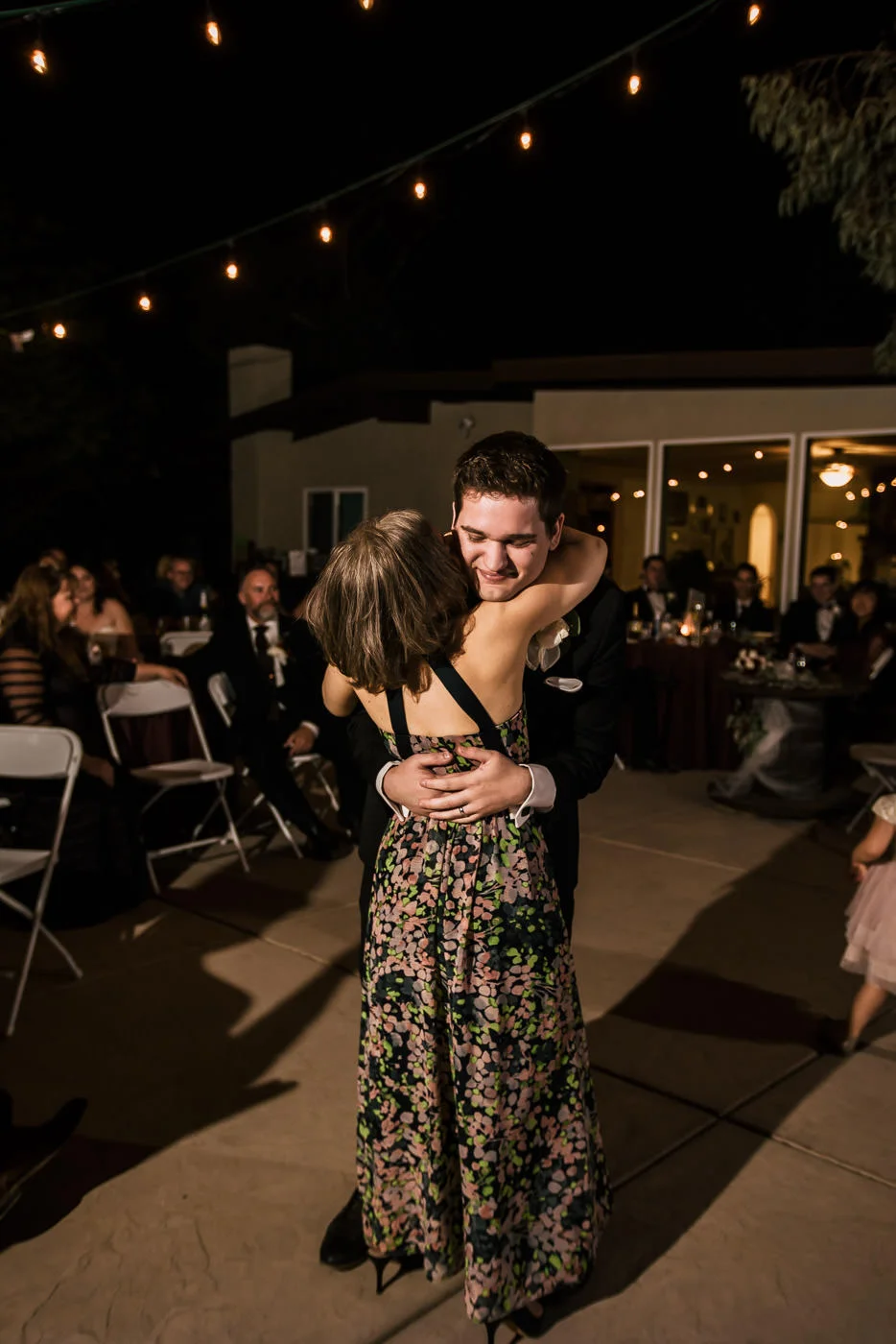 Groom dances with his mother at wedding reception.