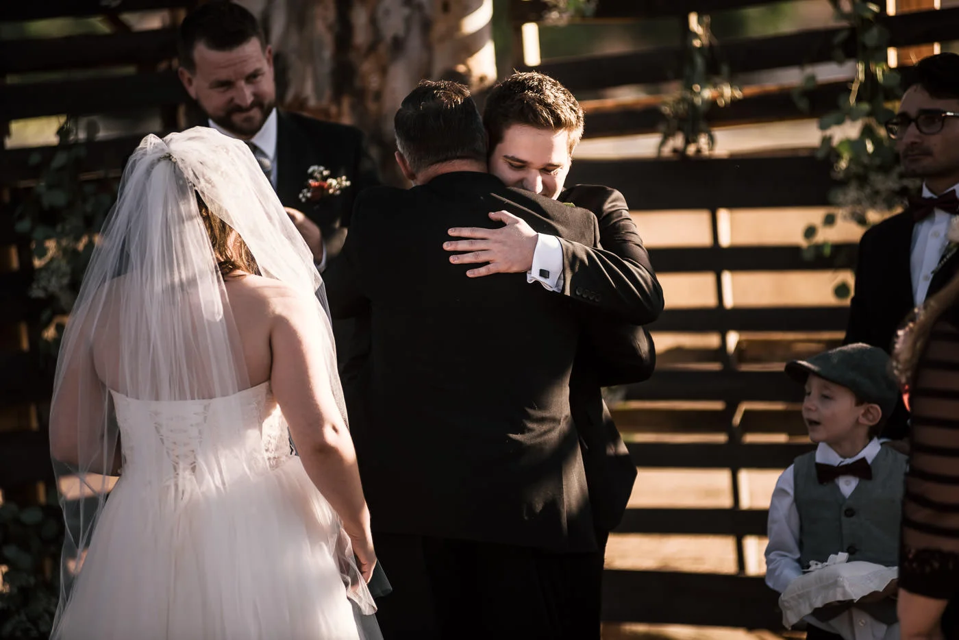 Groom hugs his father in law in touching photograph at their Temecula wedding.