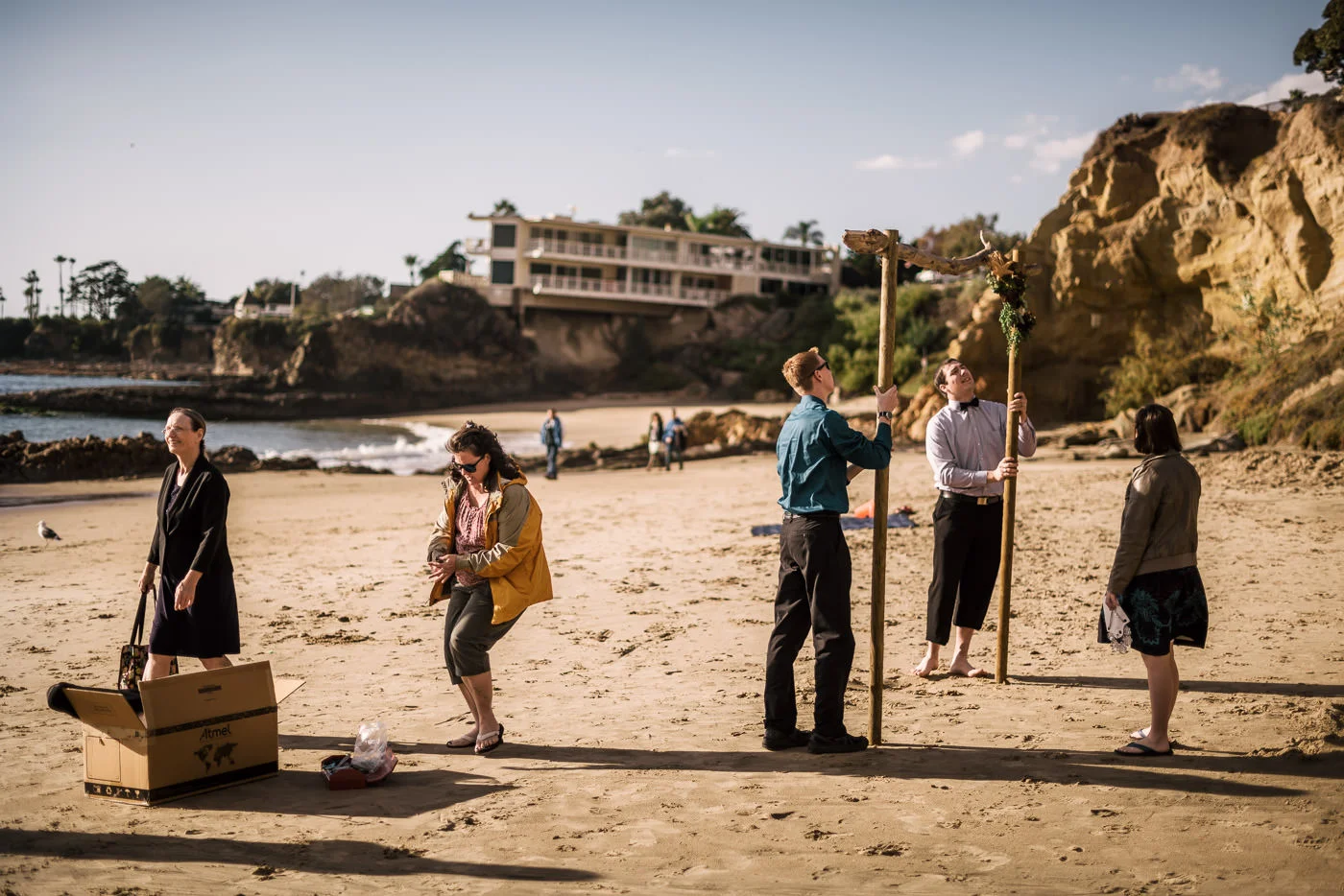 Family and friends help set up the driftwood altar for the ceremony at Laguna Beach.