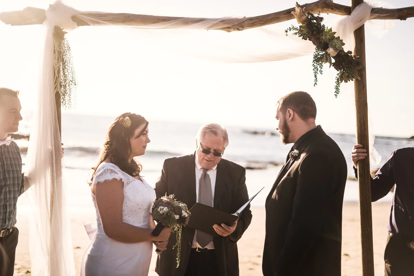 Beautiful Laguna Beach wedding ceremony captured by photographer at sunset.