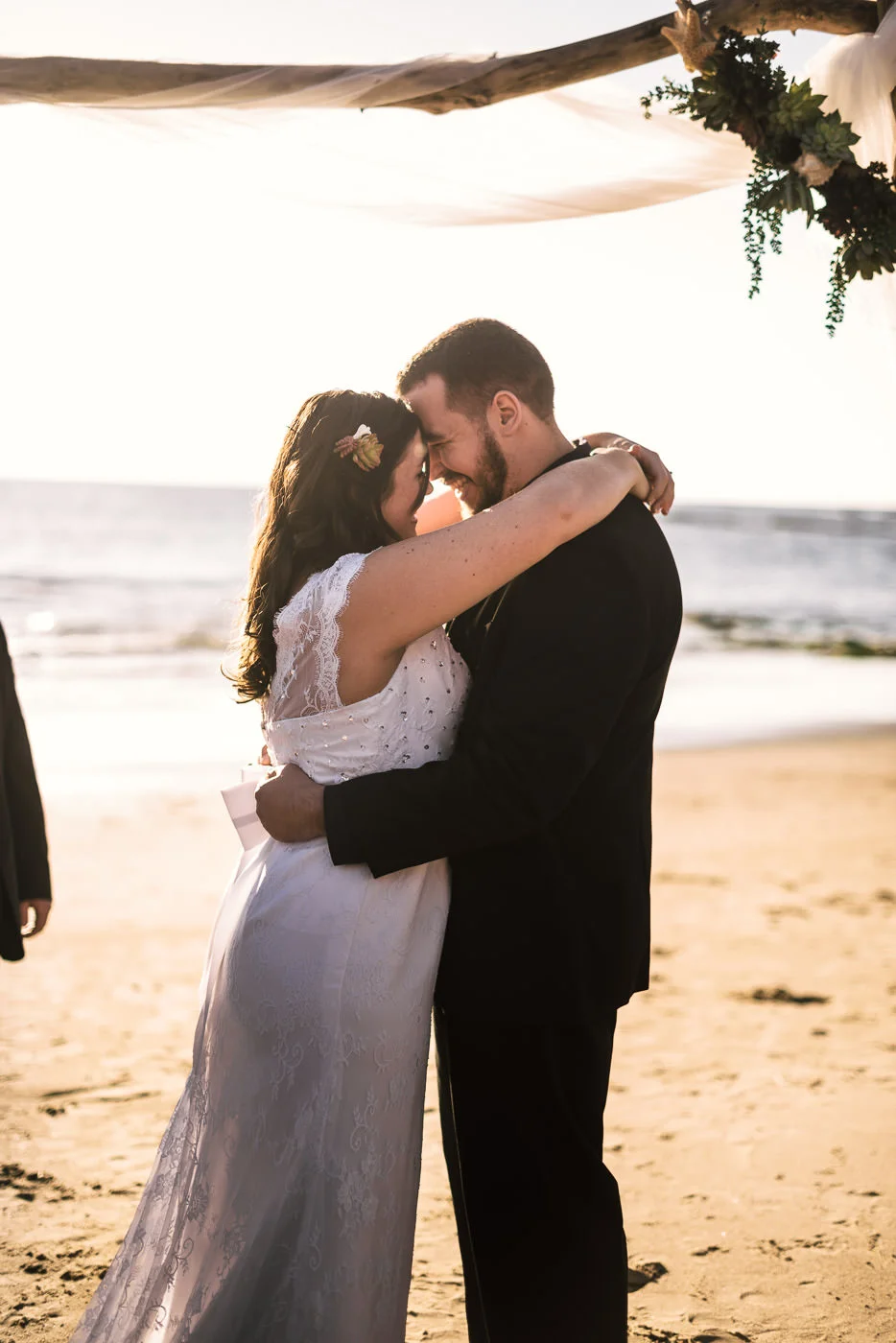 Newly married couple stare deeply into each others eyes after their wedding at Laguna Beach.