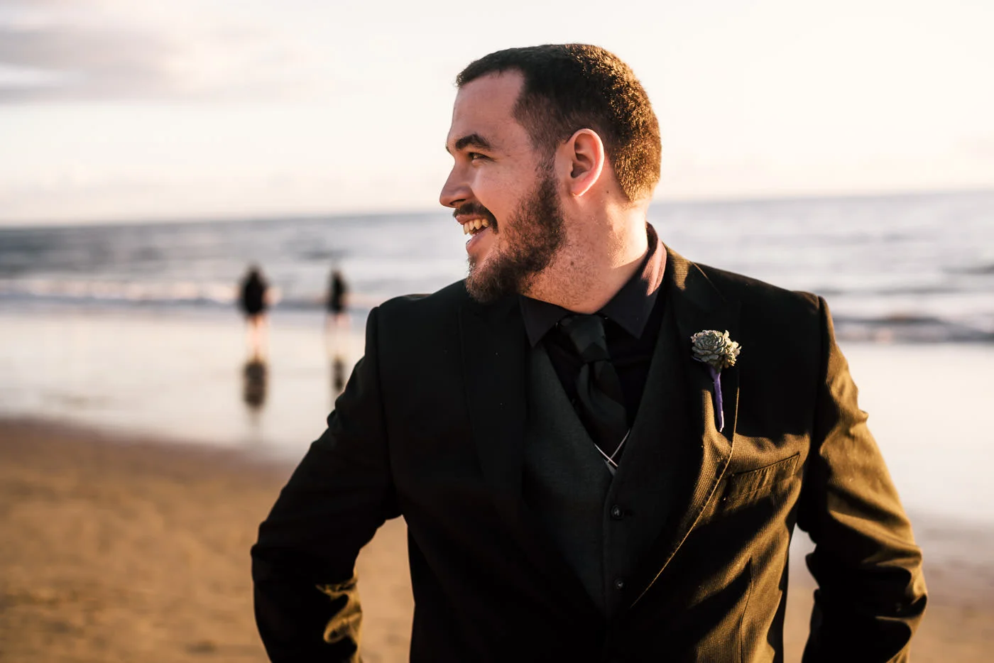 Joyful groom looks at his lovely bride and is overcome with a smile.