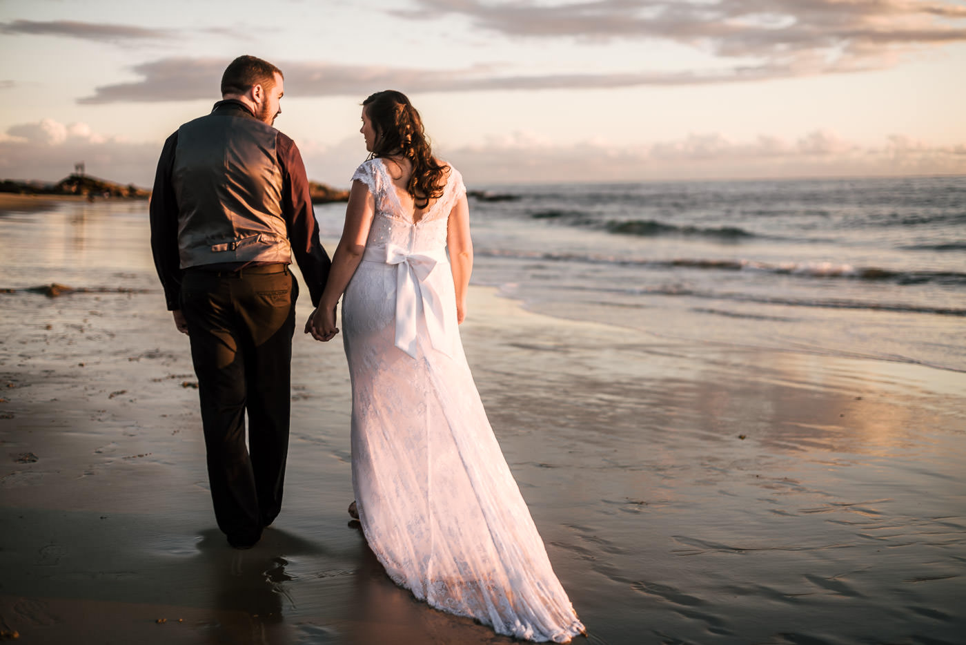 Couple takes a romantic stroll down the beach for their elopement in Laguna Beach.