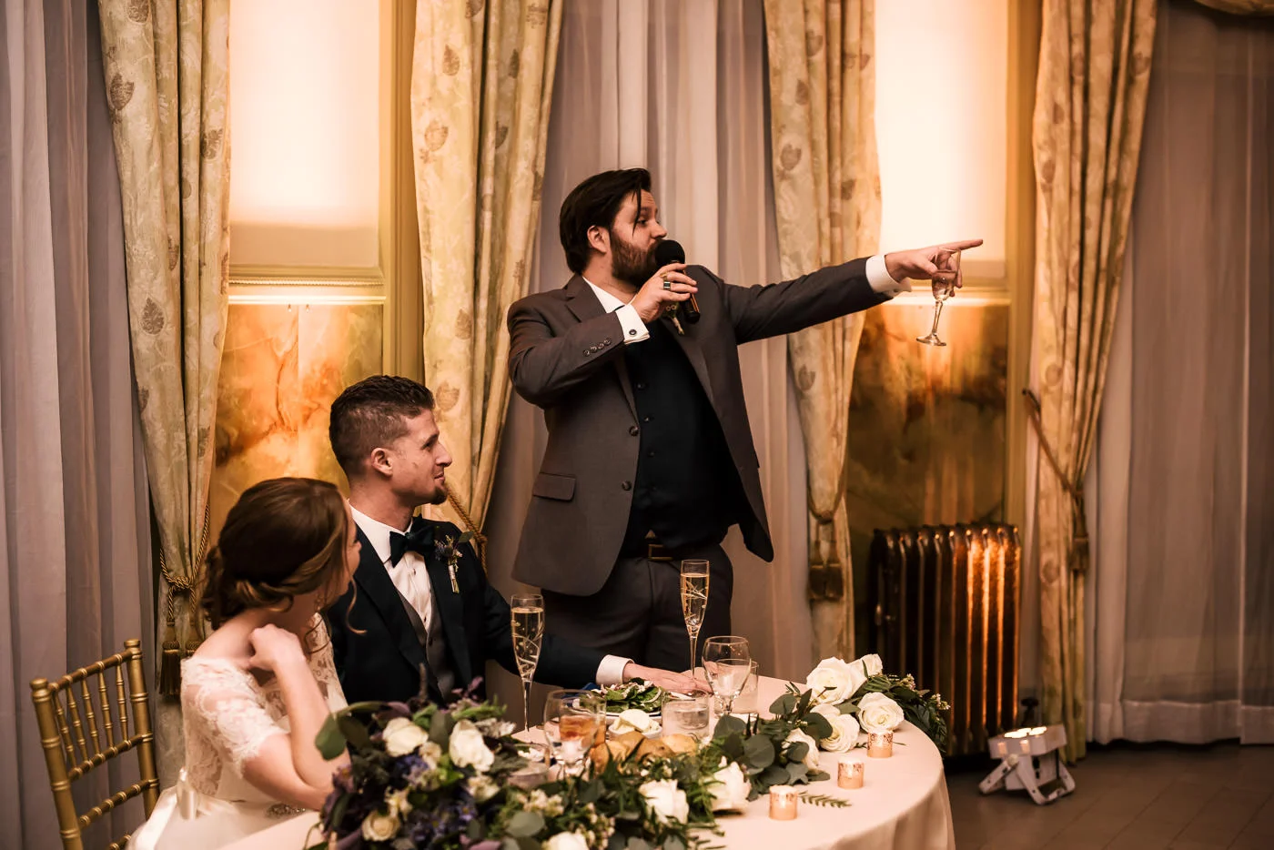 Best man gives a beautiful toast at the wedding reception.