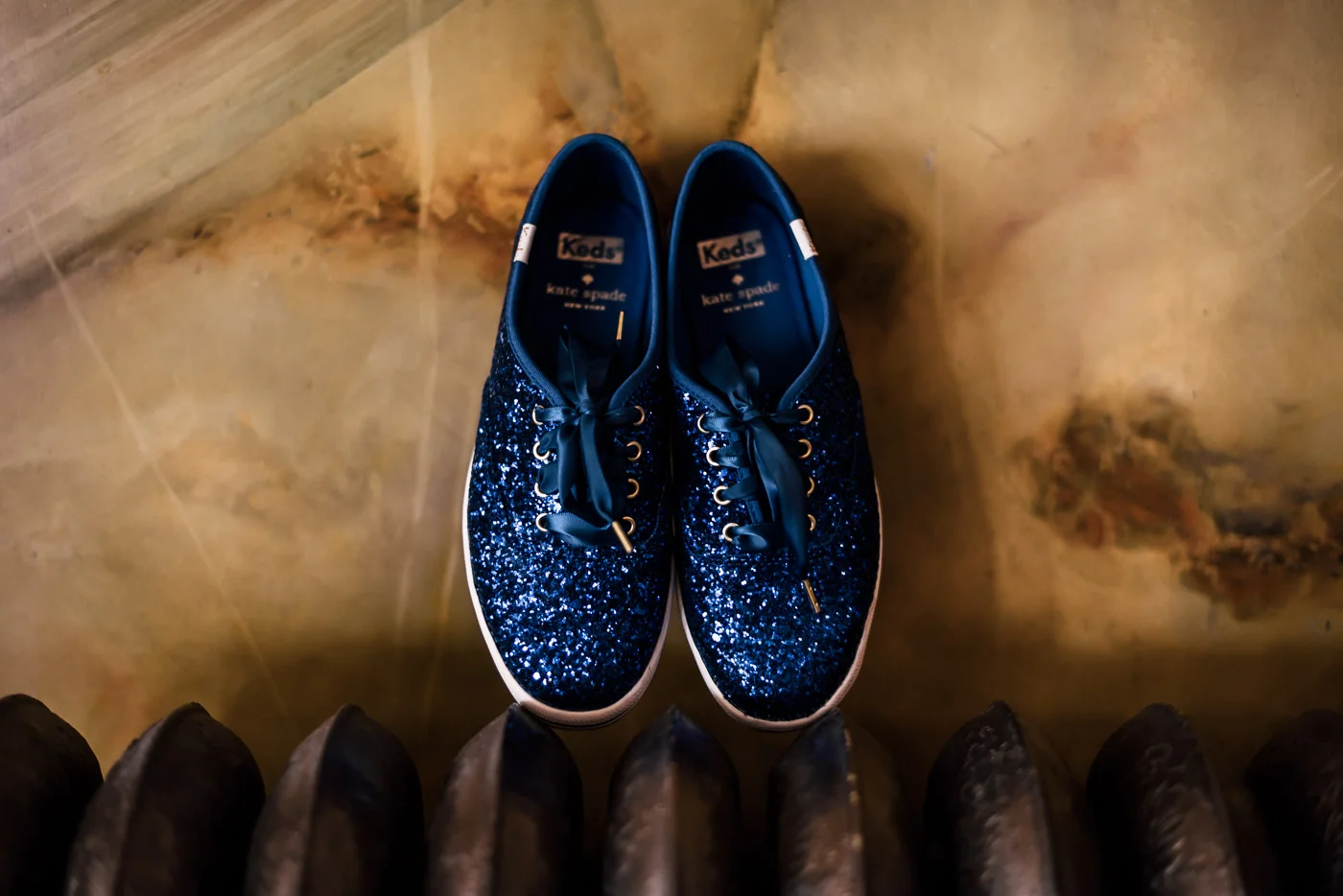 Bride choses Blue sparkle Kate Spade Keds for her wedding reception shoes.