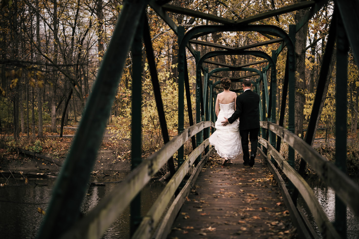 groom gives his bride a squeeze as their michigan elopement in fall