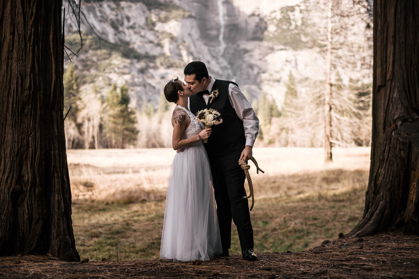 couple kisses after tying the knot in yosemite national park