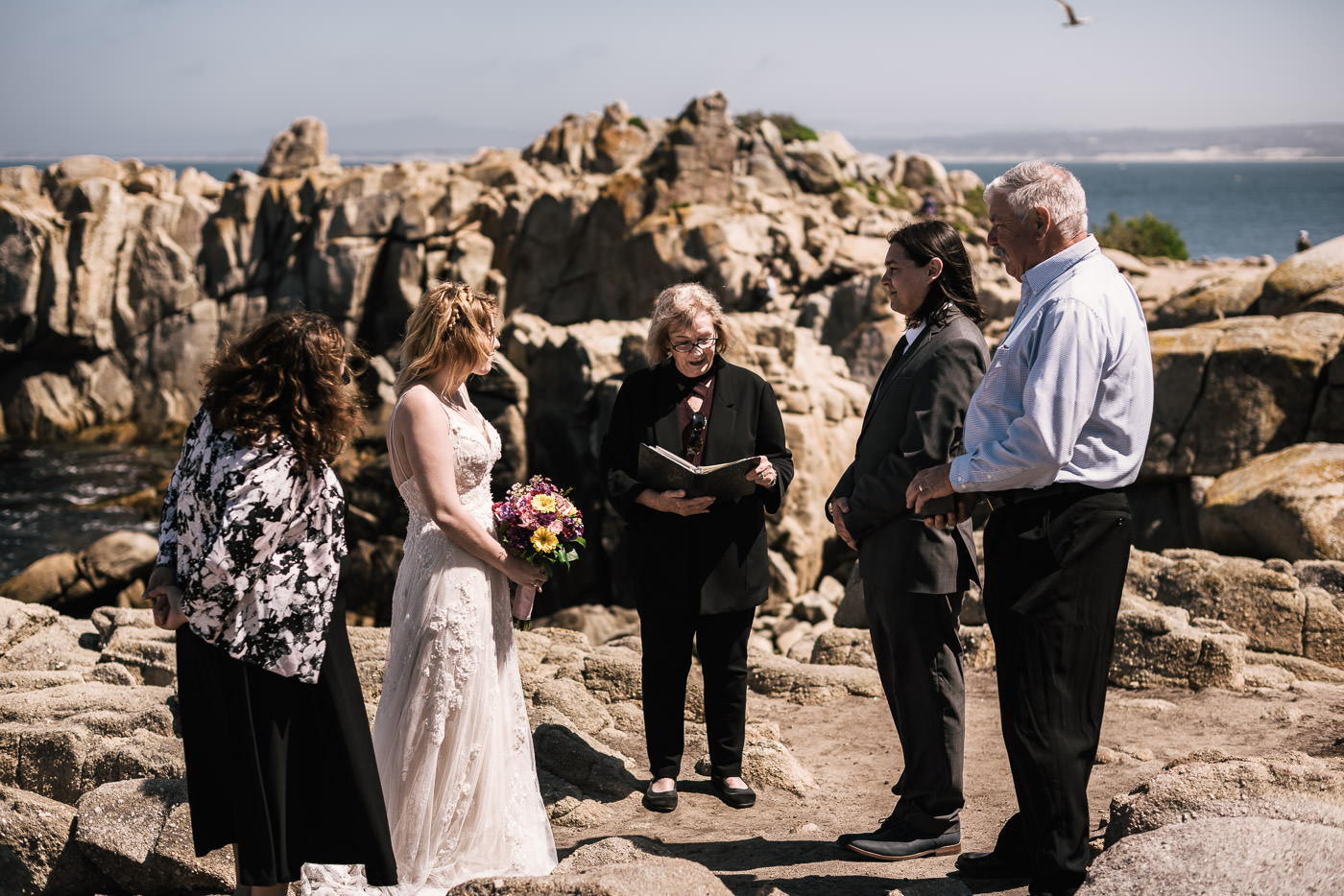 Wedding officant conducts the marriage ceremony in Monteray California.