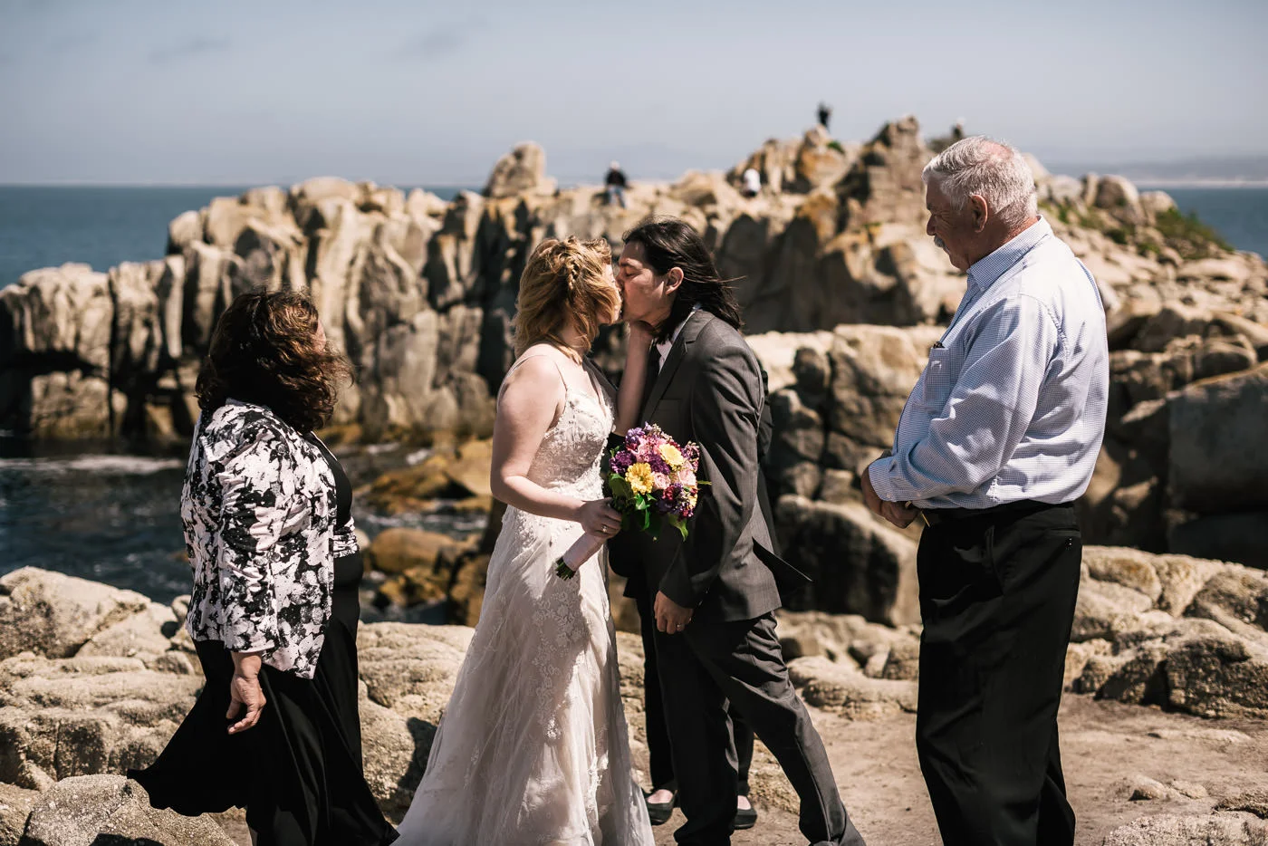 First kiss at a romantic wedding ceremony at Lovers point in Pacific grove.