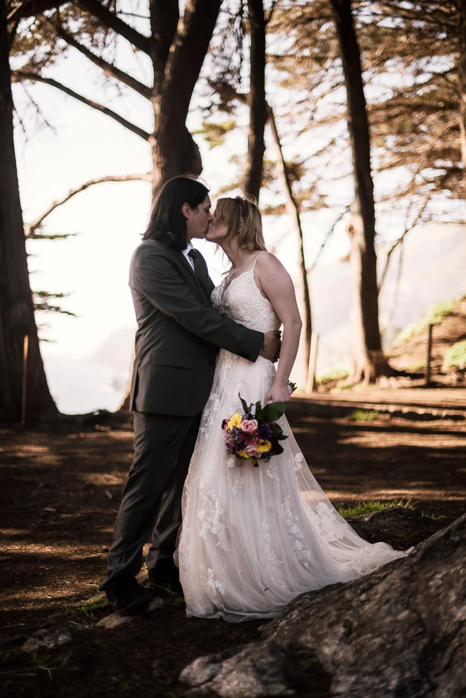 Kiss beneath the pines on the coast of California.