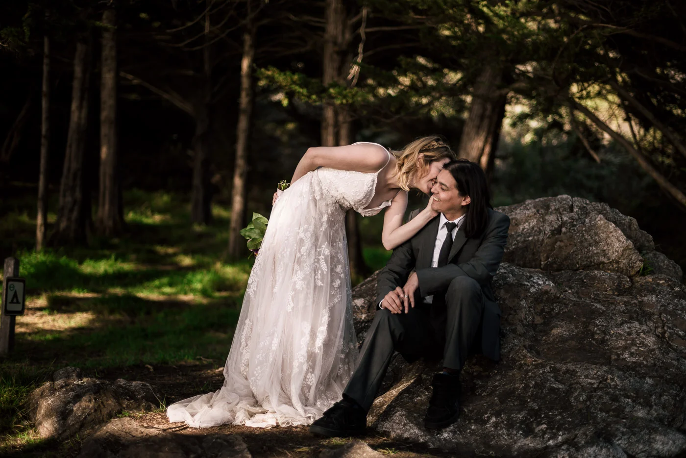 Loving bride whispers in her husbands ear.
