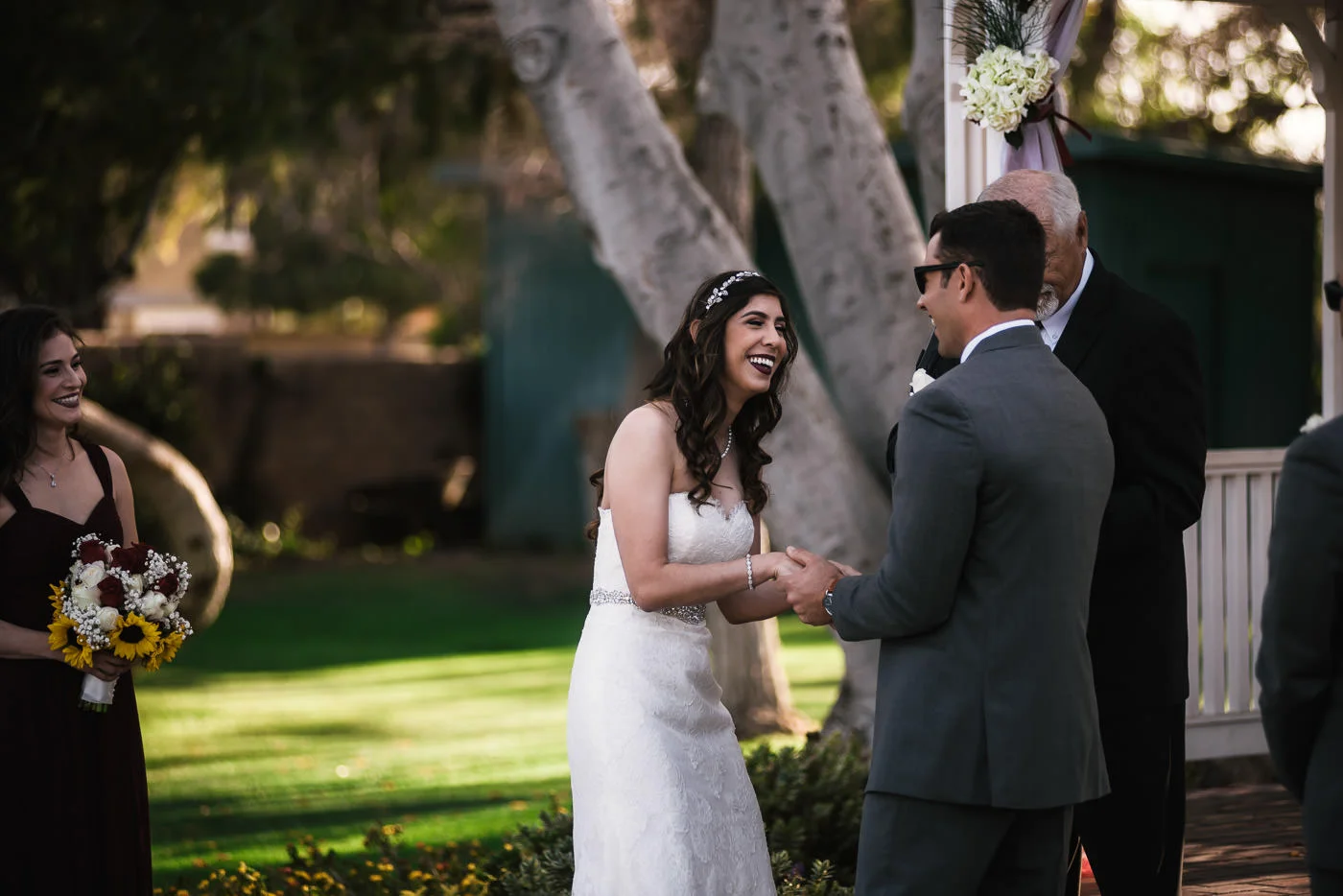 Bride laughs as her groom says his marriage vows.