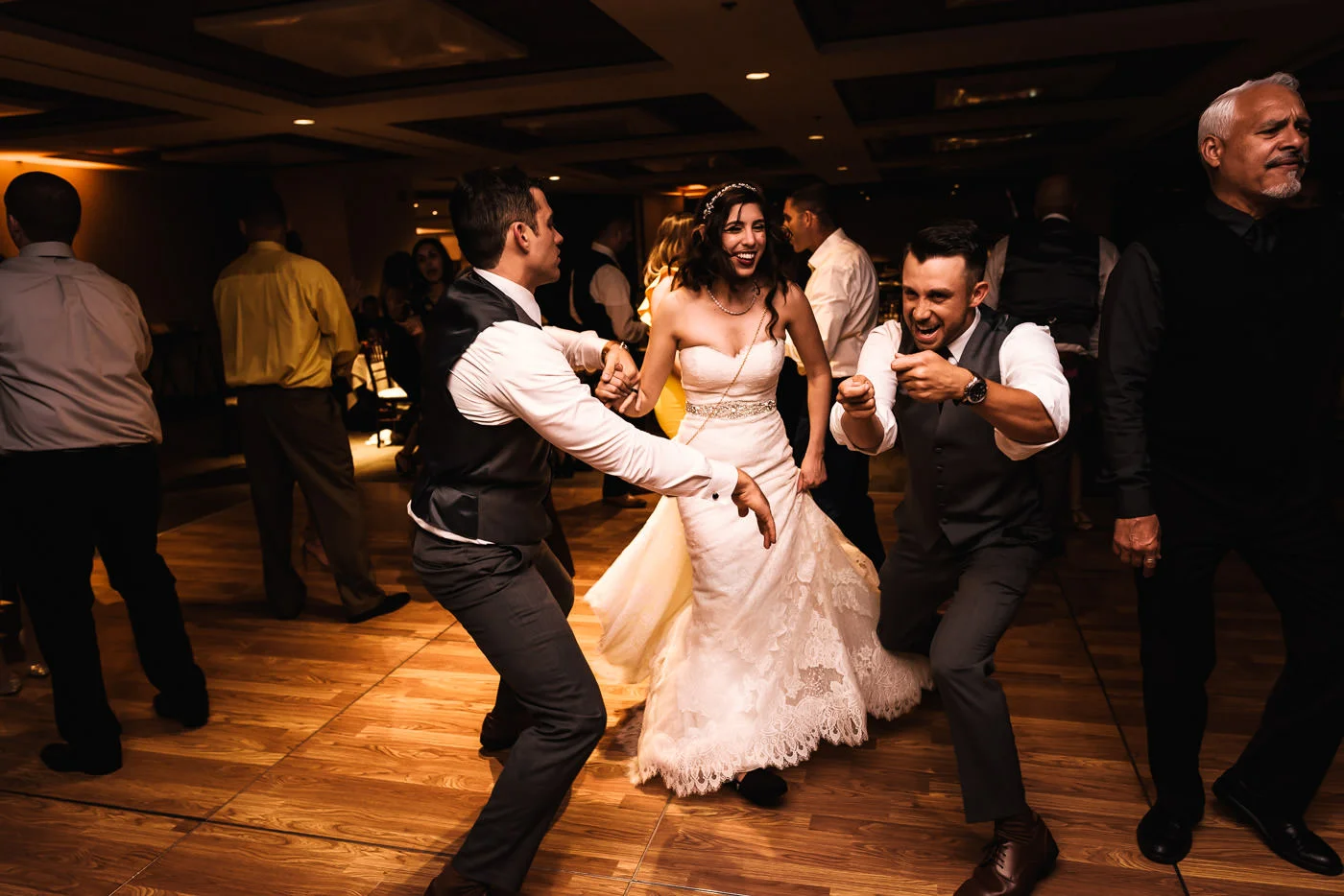 Couple dances with their guests at the reception.