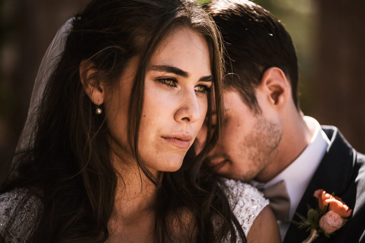Groom rests his head on his beautiful bride for a romantic wedding photo in San Diego.