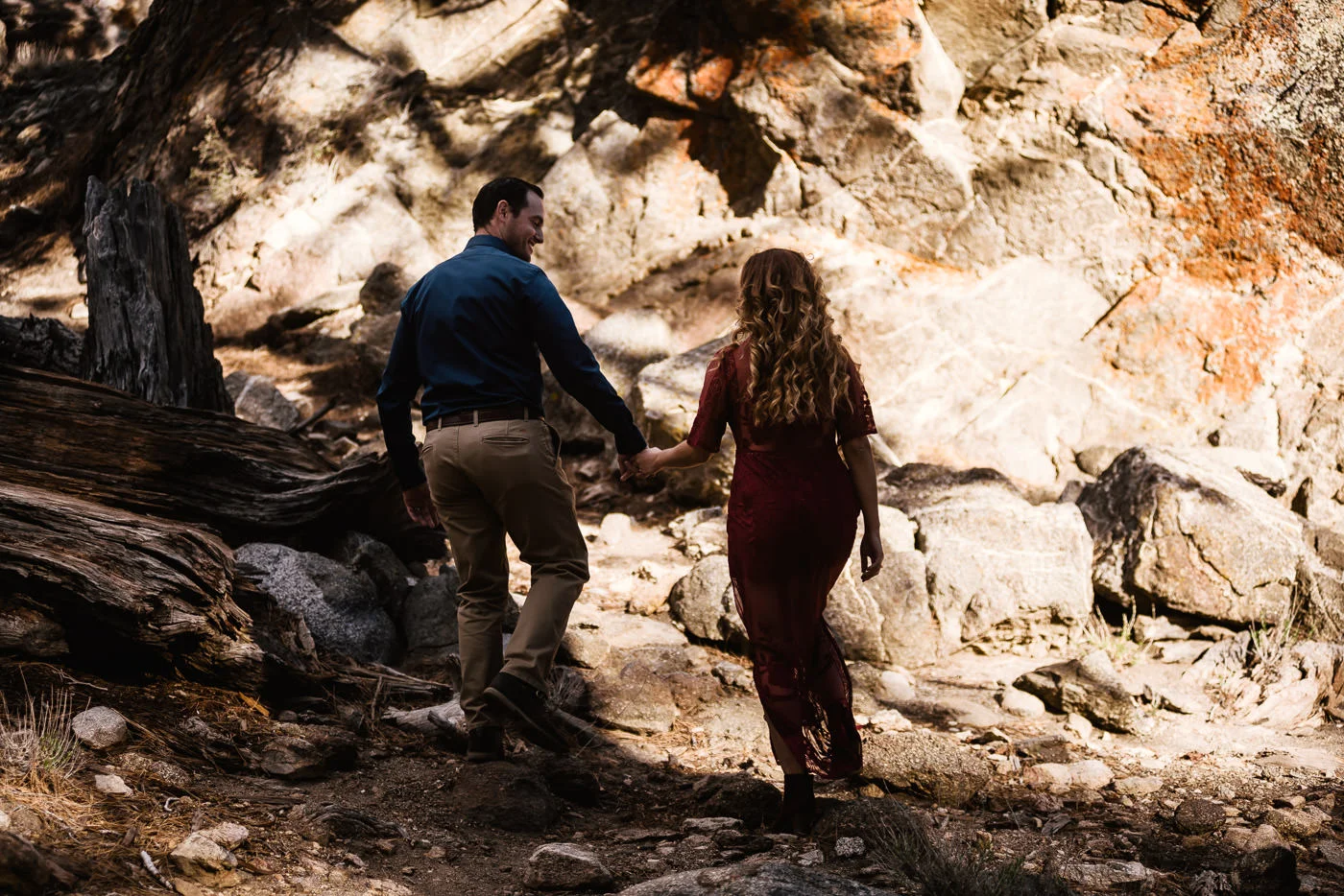 Groom to be leads his fiance through the forest.