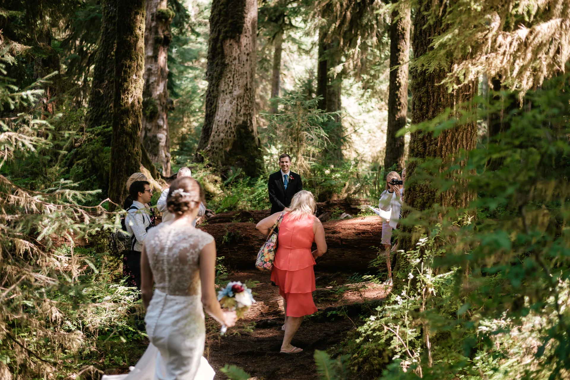 Bride arrives at her intimate marriage ceremony in the Hoh Rainforest.