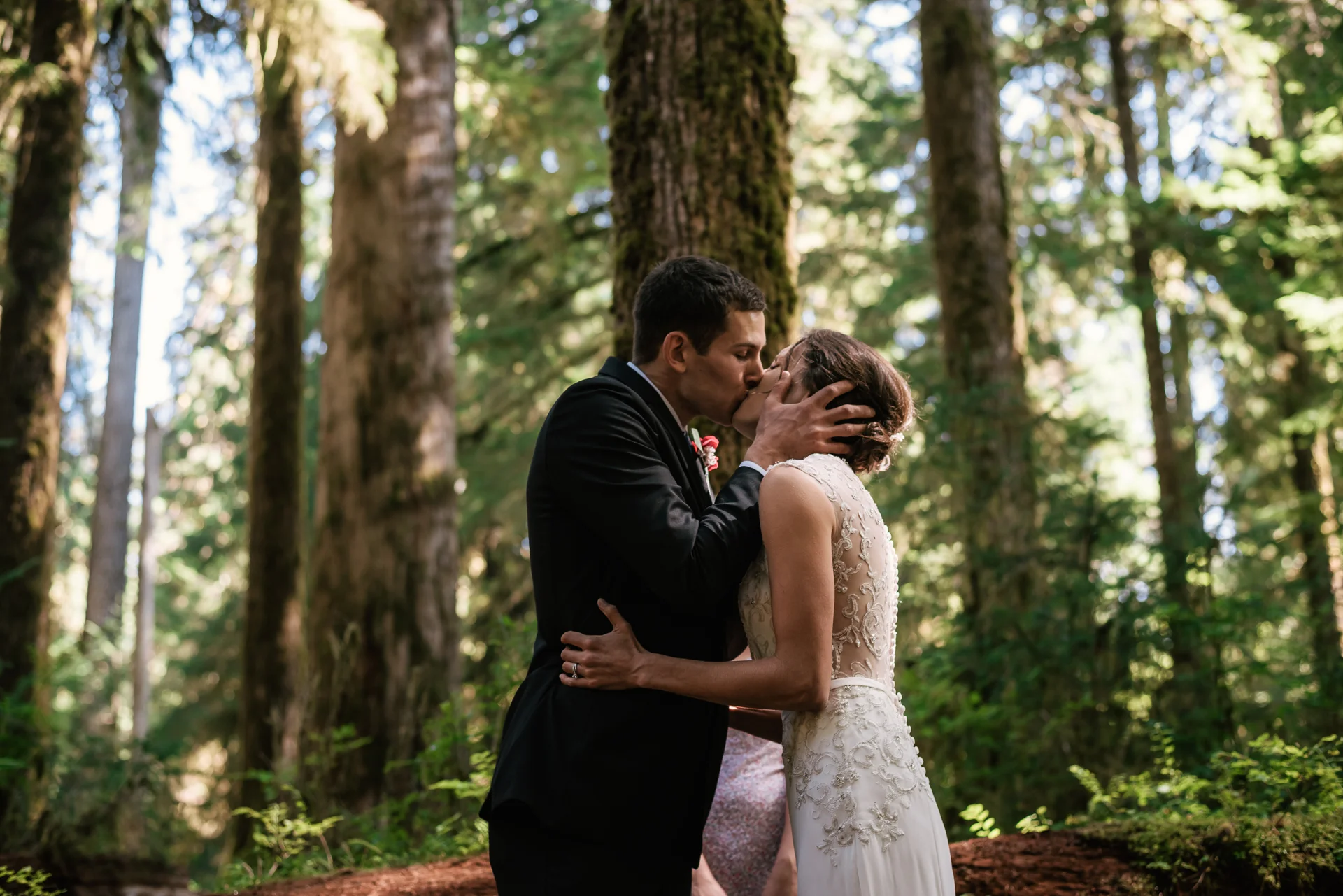 First kiss during this touching elopement to the Hoh Rainforest in Olympic National Park.