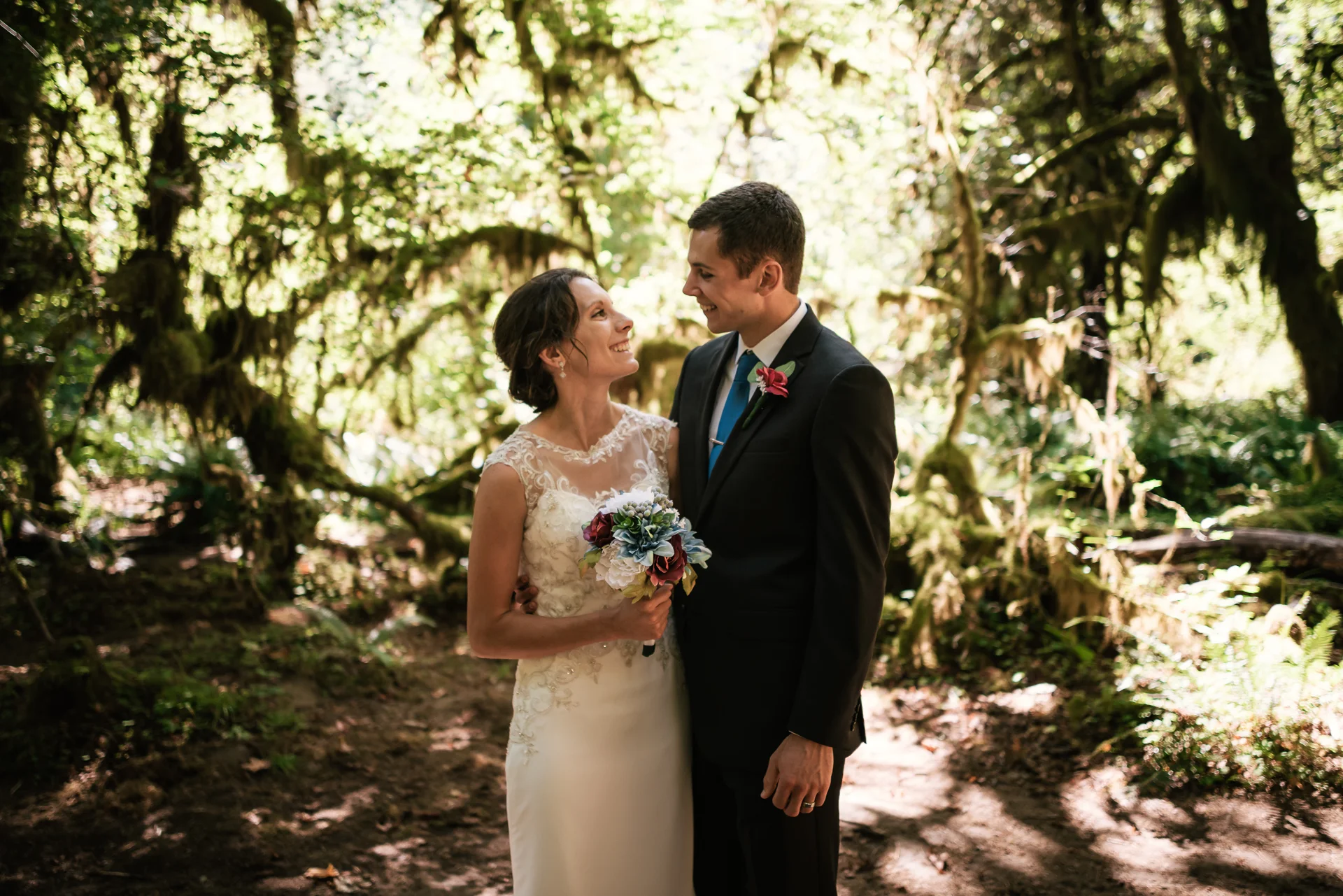 Couple stares lovingly at one another as they pose for their elopement photographer.