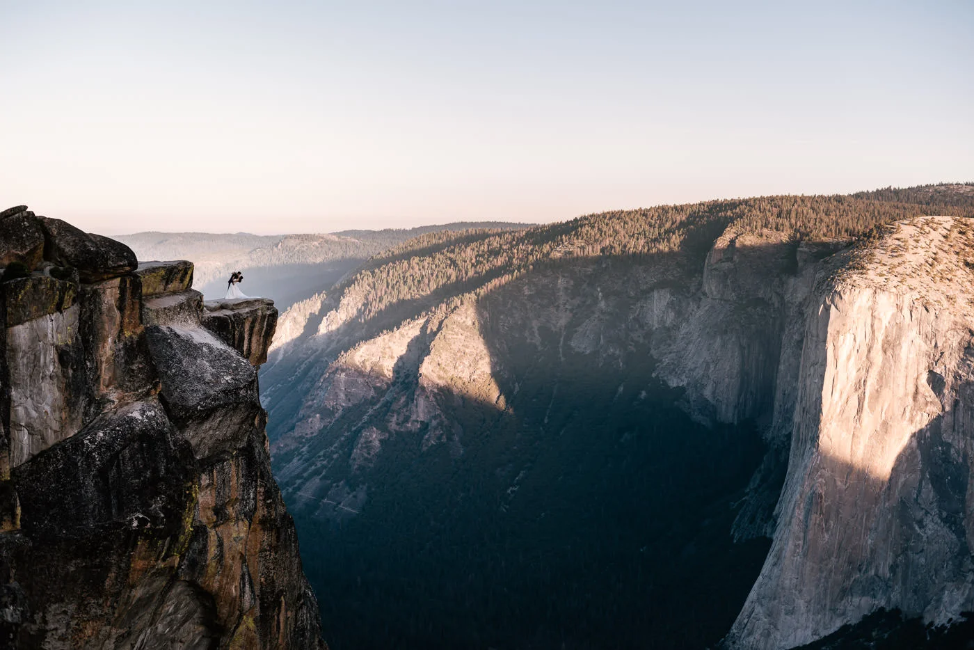 Dramatic photograph of a couple kissing at Taft Point.