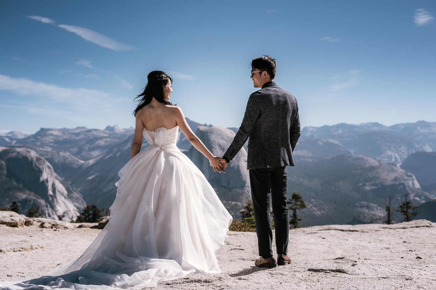 Two love birds hold hands and smile at each other during their Sentinel Dome elopement.