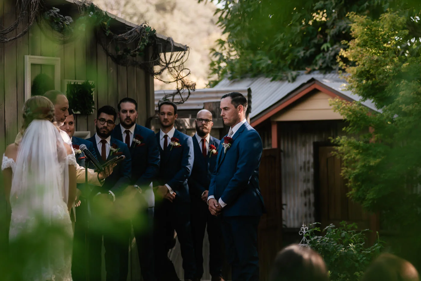 Groom listens to the pastor speak as he prepares to say his vows.