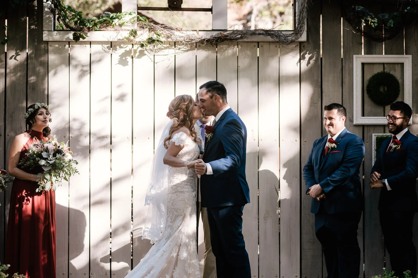 Couple leans in for their first kiss as husband and wife.
