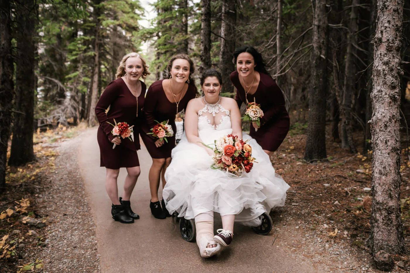 Bride poses with her bridesmaids as they travel down the trail to the ceremony site at Switcurrent Lake.