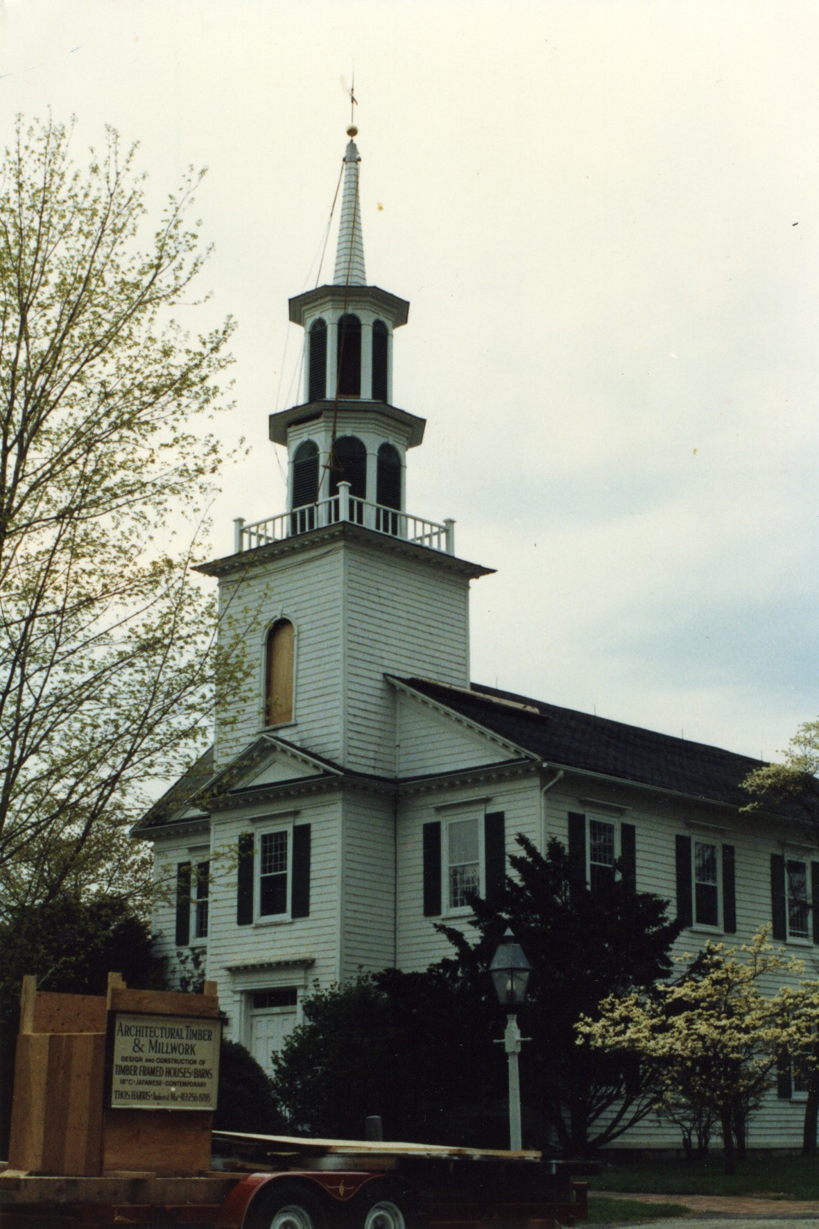 A two cupola steeple with spire atop narthex.