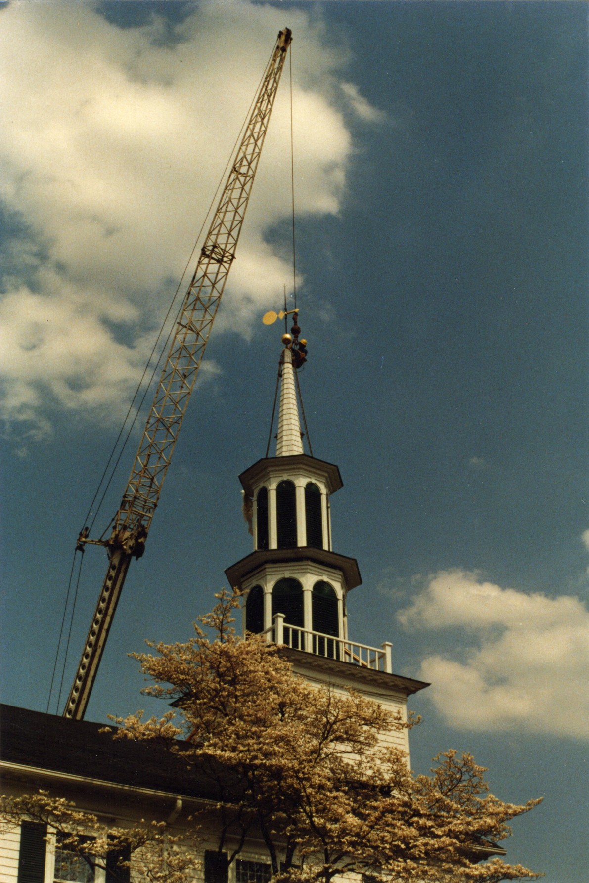 A two cupola steeple with spire atop narthex..