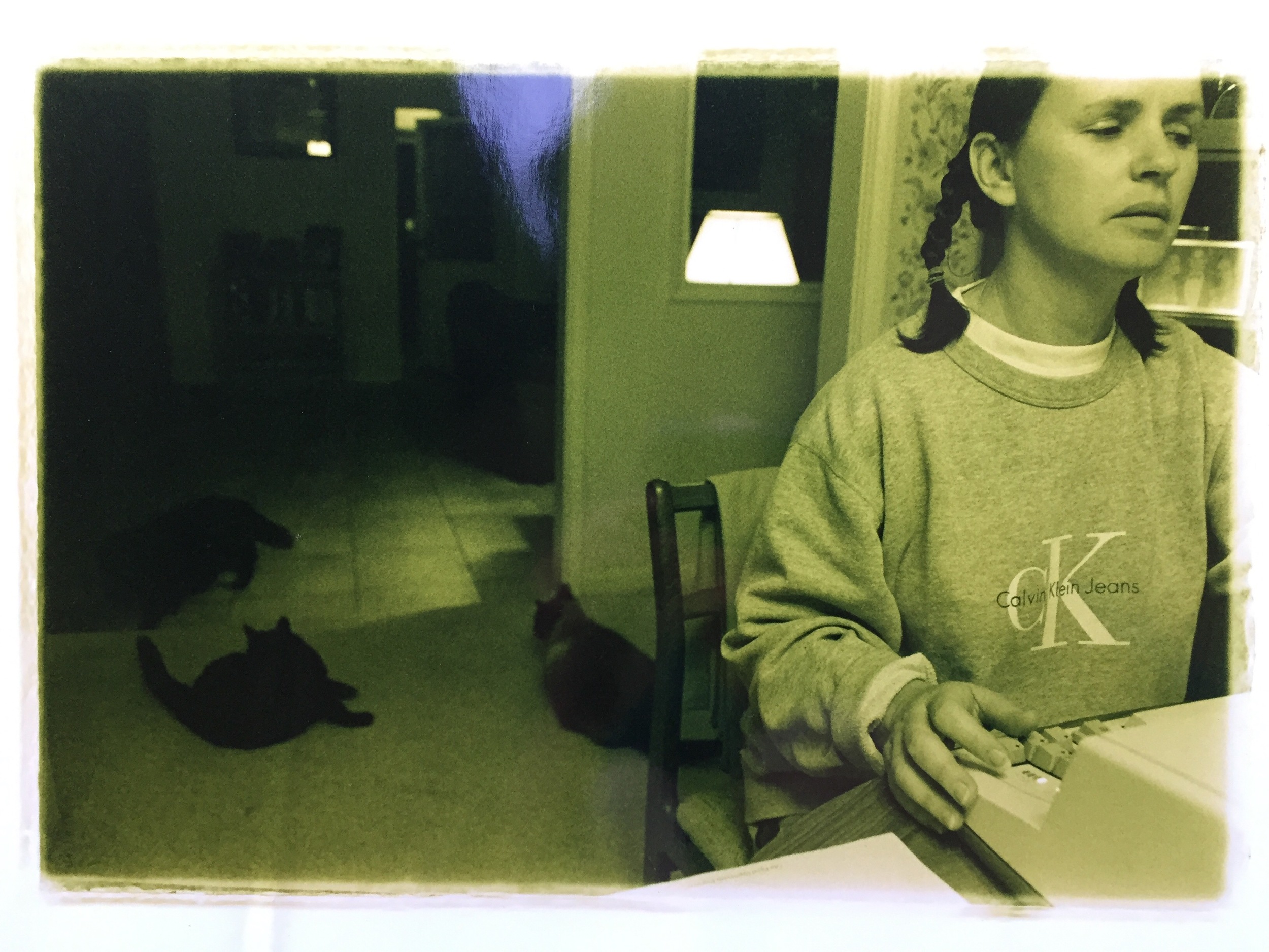 In between braiding her hair and tossing myself on the floor (by the cats), I photographed mom as she worked on my applications.
