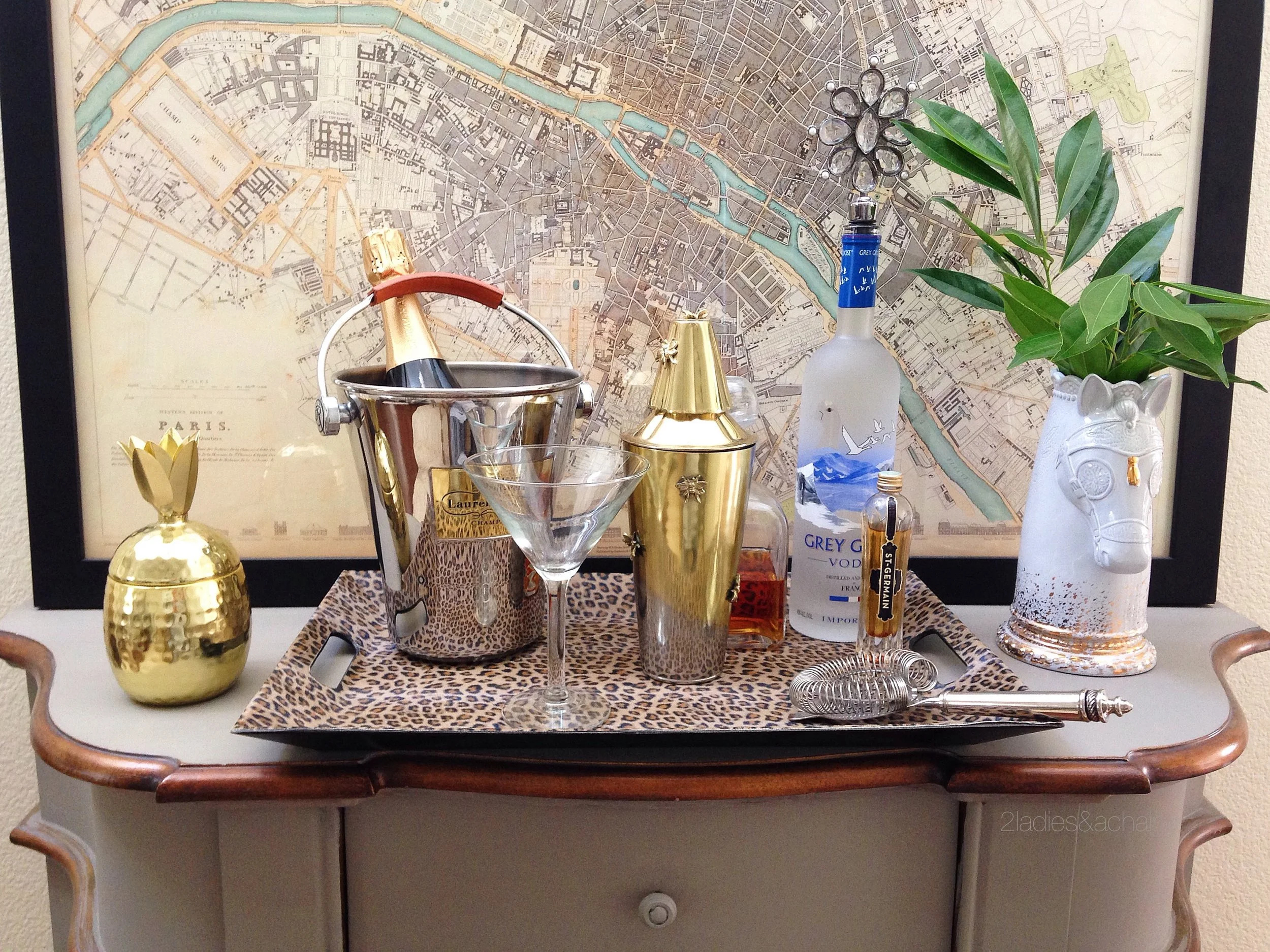 No bar cart, no problem. A tray on top a console table or chest of drawers is a perfect spot for a bar.