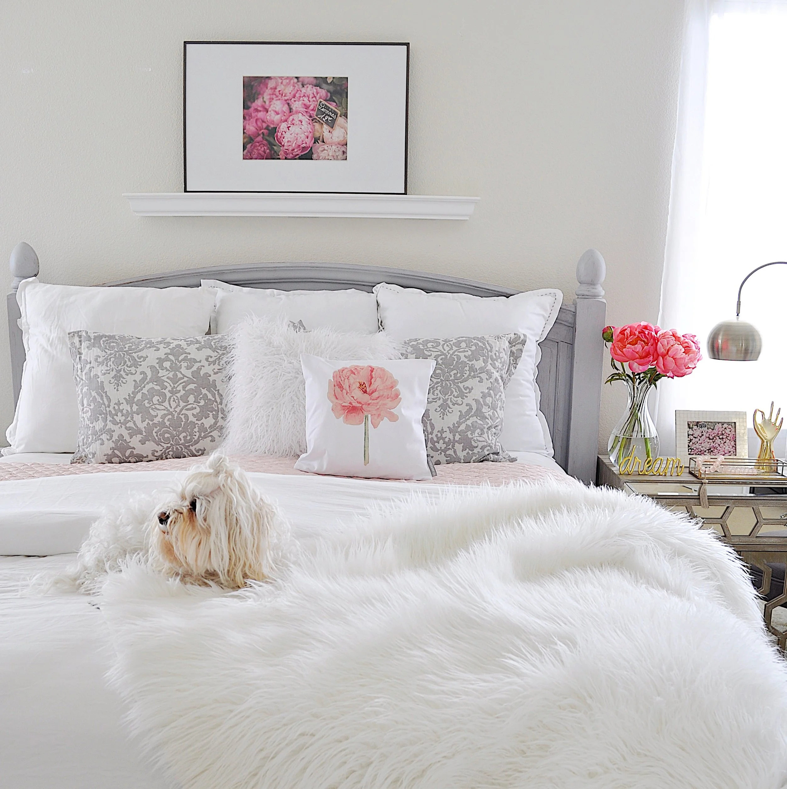 All white bedding with a touch of blush has the luxurious feeling of a resort; Carmen loves it!