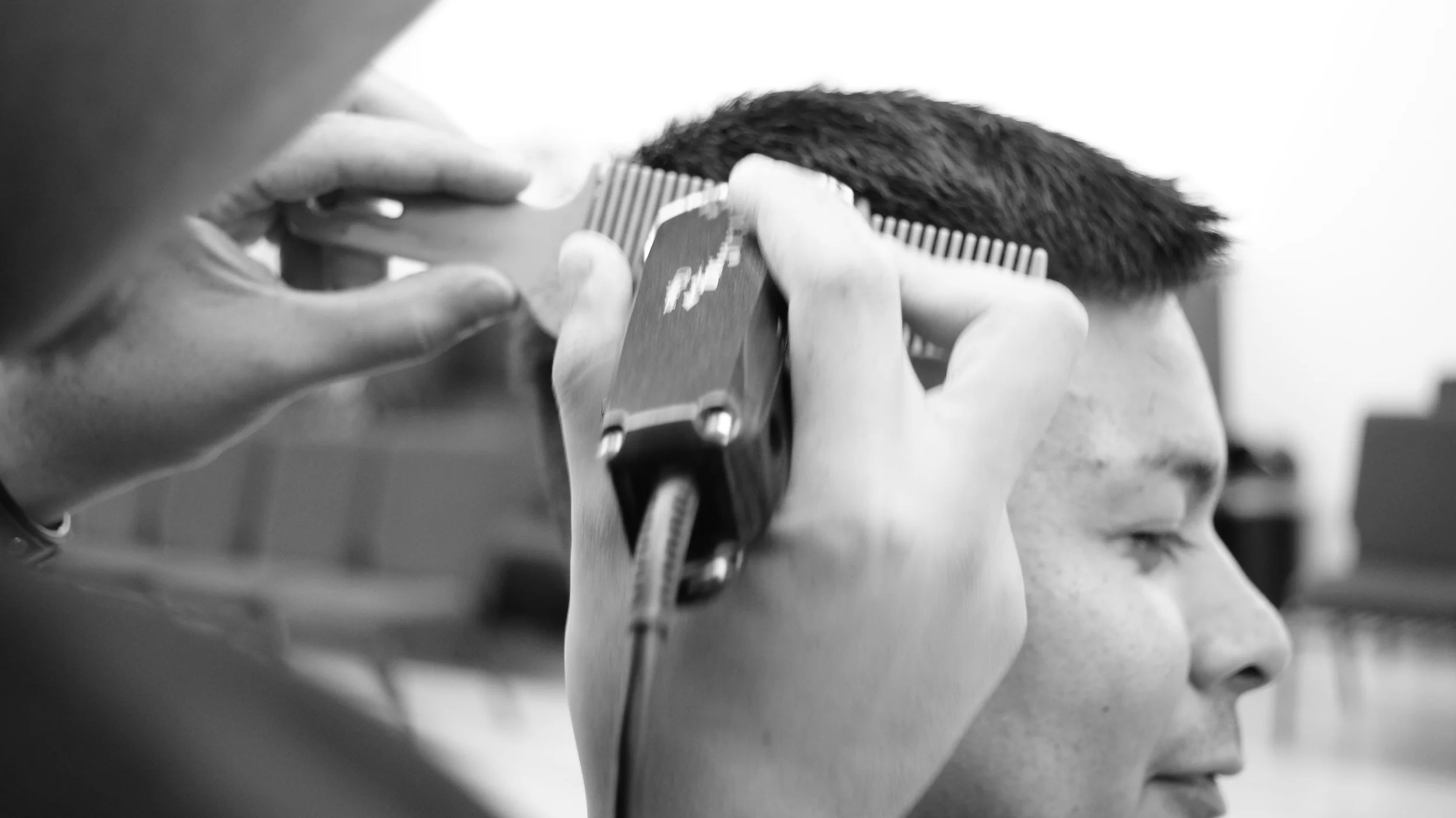 German performing the clipper over comb technique