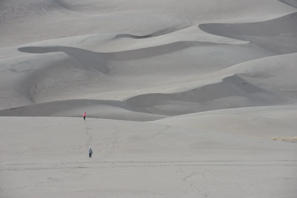 kids running in the  great sand dunes