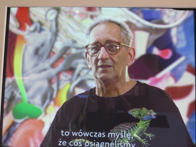 Frank Stella being interviewed at San Francisco Museum of Modern Art, October 2002. Photo of video playing at Polin Museum, Warsaw. https://search.yahoo.com/yhs/search?p=frank+stella&ei=UTF-8&hspart=mozilla&hsimp=yhs-002