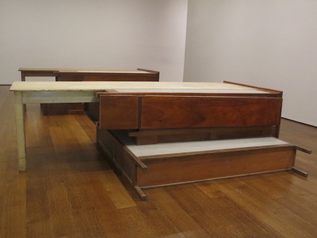 "Untitled" (2008), by Doris Salcedo. wooden tables, wooden armoires, metal, concrete. Harvard Art Museums, Cambridge, MA.