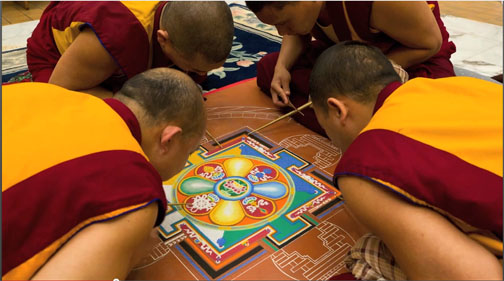 Tibetan monks creating a sand mandala. Source: https://gandenmonkstourpgh.wordpress.com/tibetan-buddhist-ritual-arts-practices/