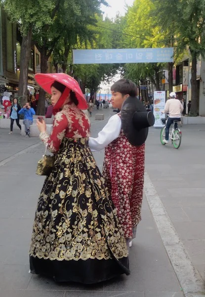 Dressed in rented hanbok , a young couple stroll through Insadong in Seoul.
