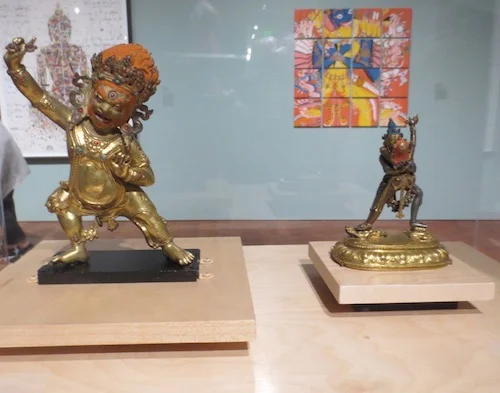 On the right, Sahaja Cakrasamvara with Vajravarahi (16th c., Tibet), silver, copper and gilt-copper. On the left, Vajrapani (16th c., Tibet), represents an unwavering ability to vanquish negativity.