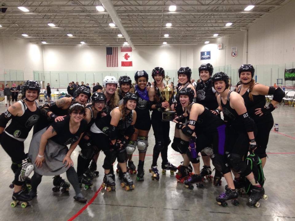 Ann Arbor Brawlstars, Mitten Kitten 2013 champions, pose with their trophy.