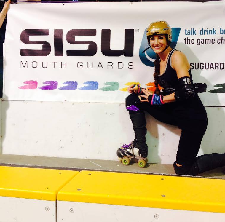 Brawlstars skater Bex takes a break from the track during a 2014 bout to show off her SISU mouthguard.