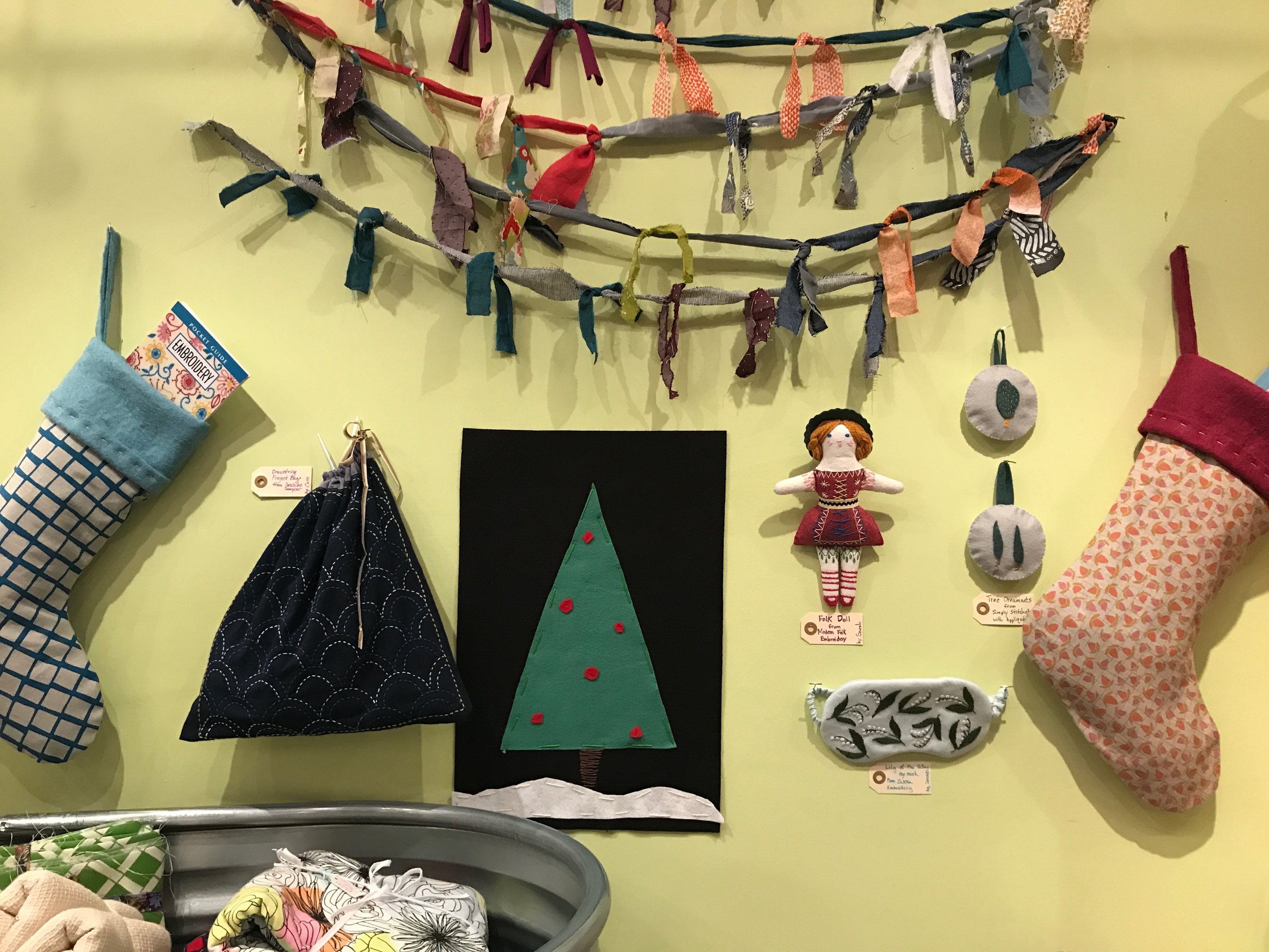 STOCKINGS and Fabric Garland Tree by Sarah frame our lovely staff stitched projects from our favorite embroidery books and samplers.