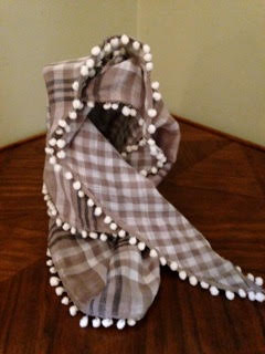 scarf from Lotta Jansdotter's book, Everyday Style , made from one of our double sided cotton gauze pieces and ball fringe. Adorable!