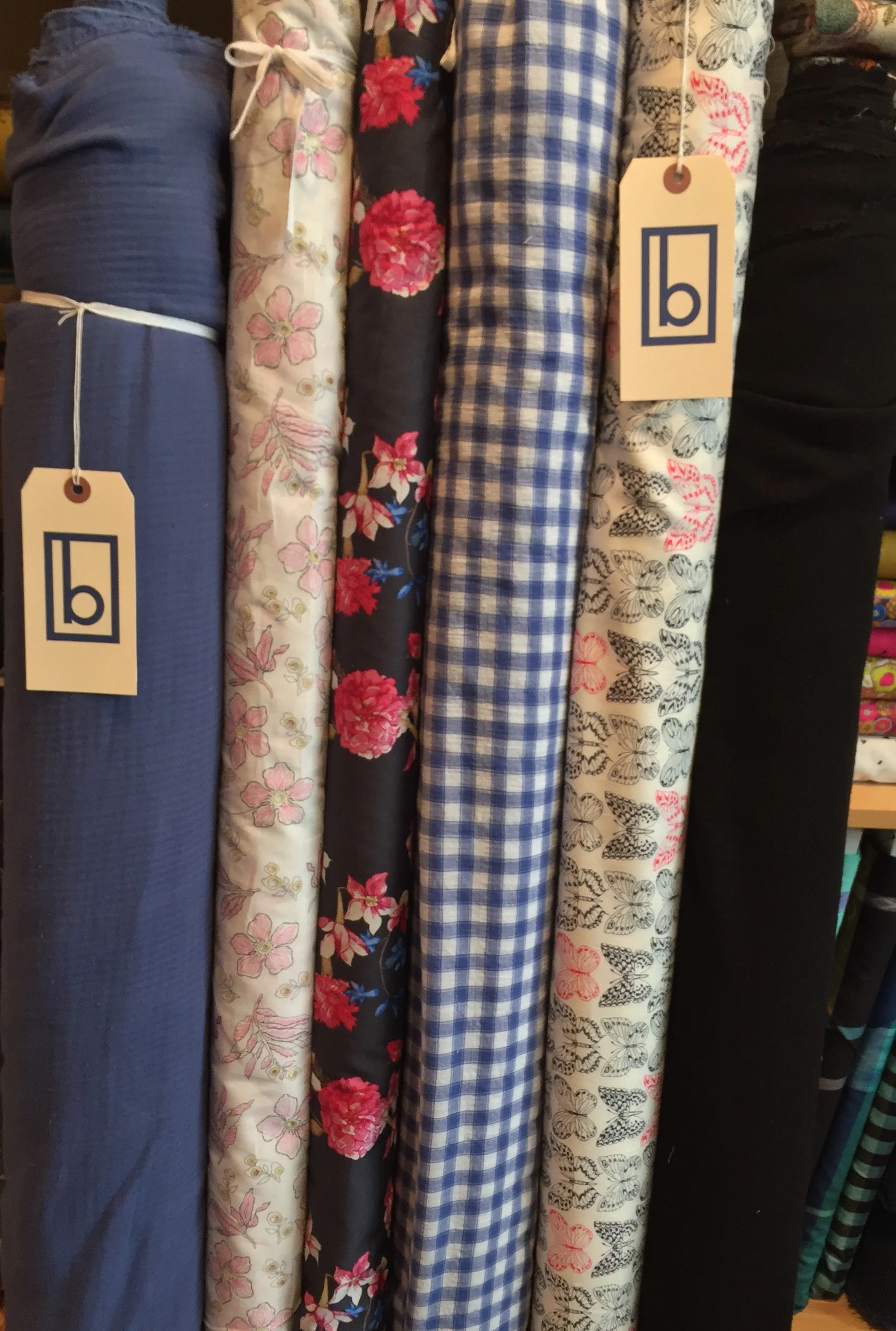 More interesting apparel goodies: super soft, herringbone double ply blue cotton, blossom eyelet print, bright floral lawn, gauzey blue check, crisp cotton butterfly and stretchy, black rayon gauze.