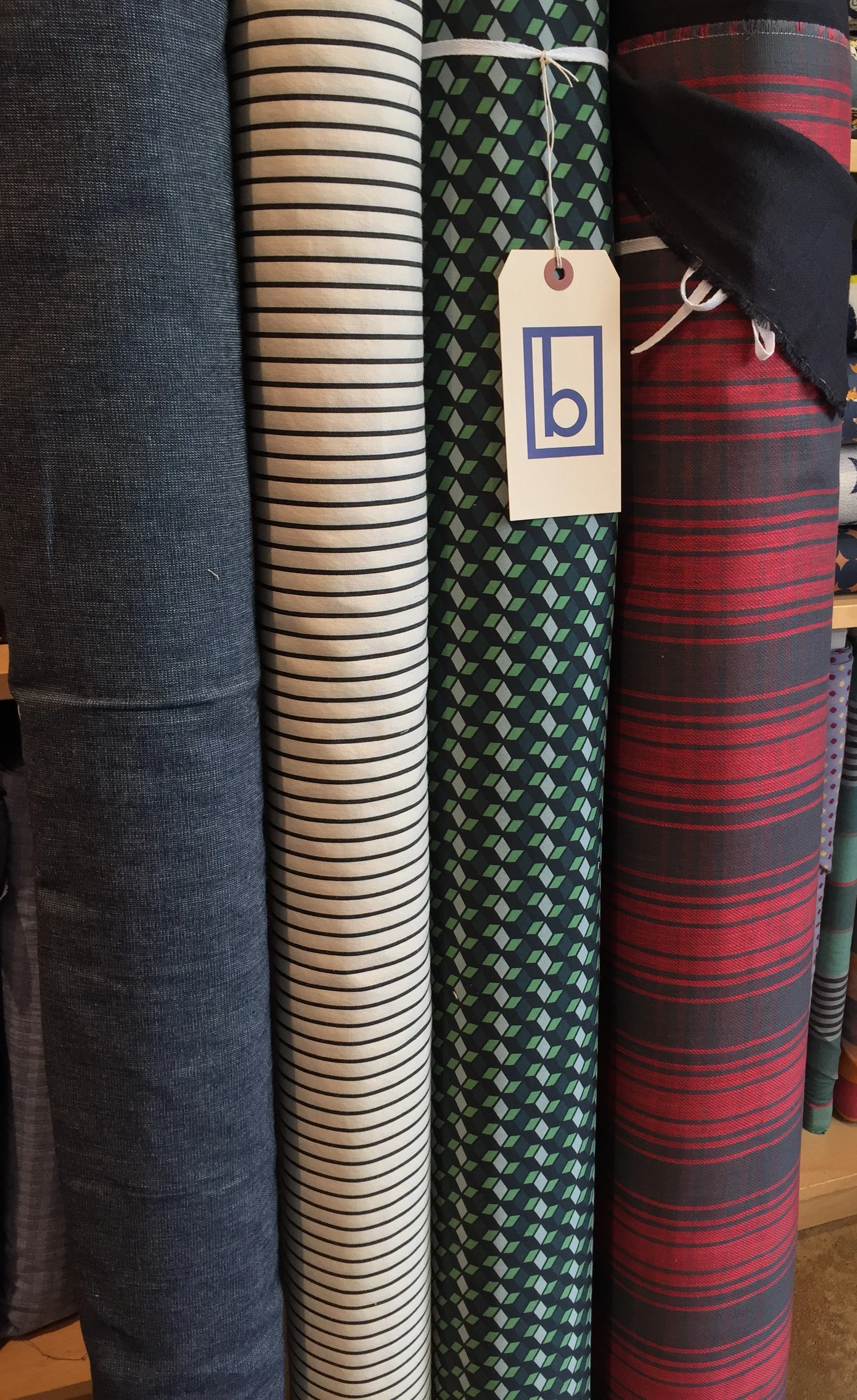 Interesting apparel goods! Plain weave cotton denim, mid weight cotton stripe, cotton/spandex bottom weight with 3D block design, and double sided cotton plaid.