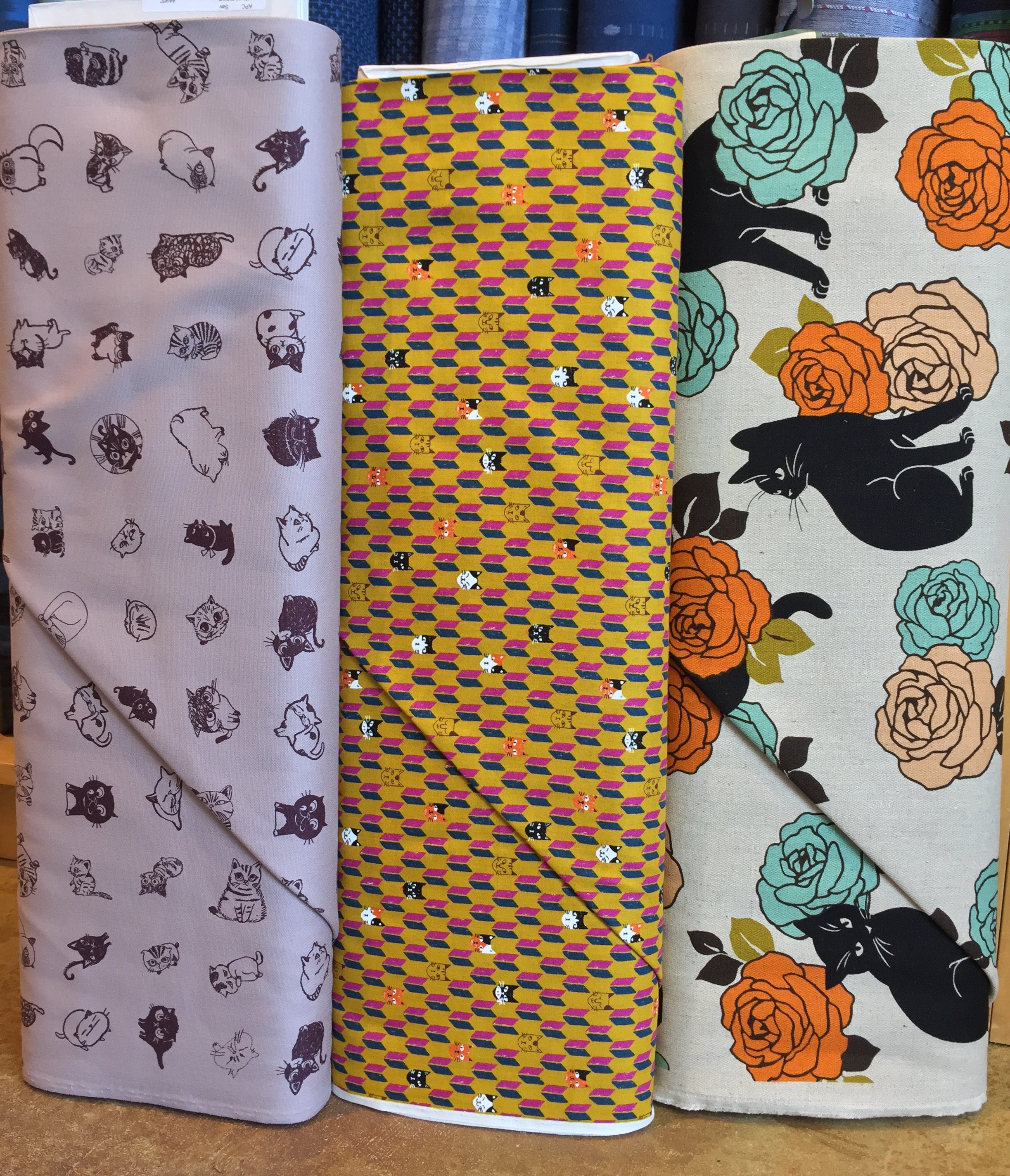 Kitty cat prints! Currently enamored with the black kitties on herringbone natural linen blend with the orange and aqua roses....