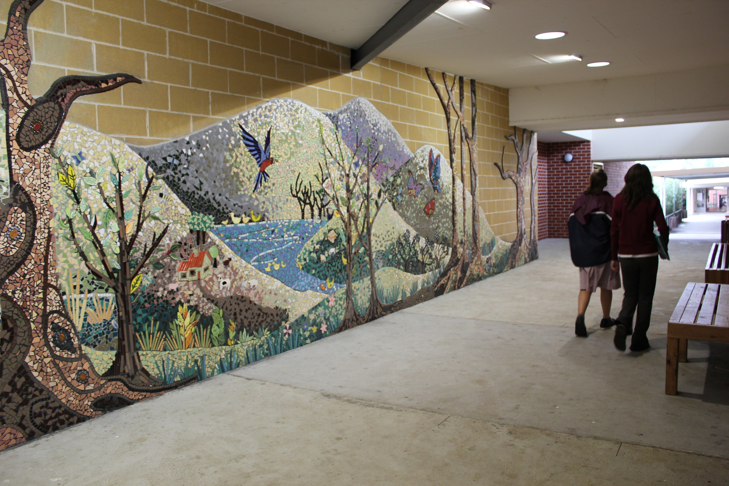 Artist in residence Lily Dale High. Part of the walk way mosaic depicting regeneration after the fires affected members of the school community.