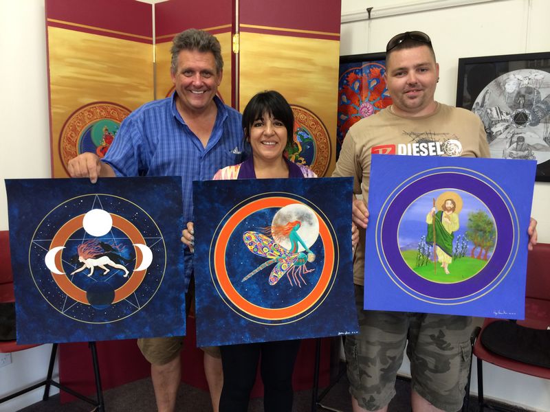 Family memebers create mandalas