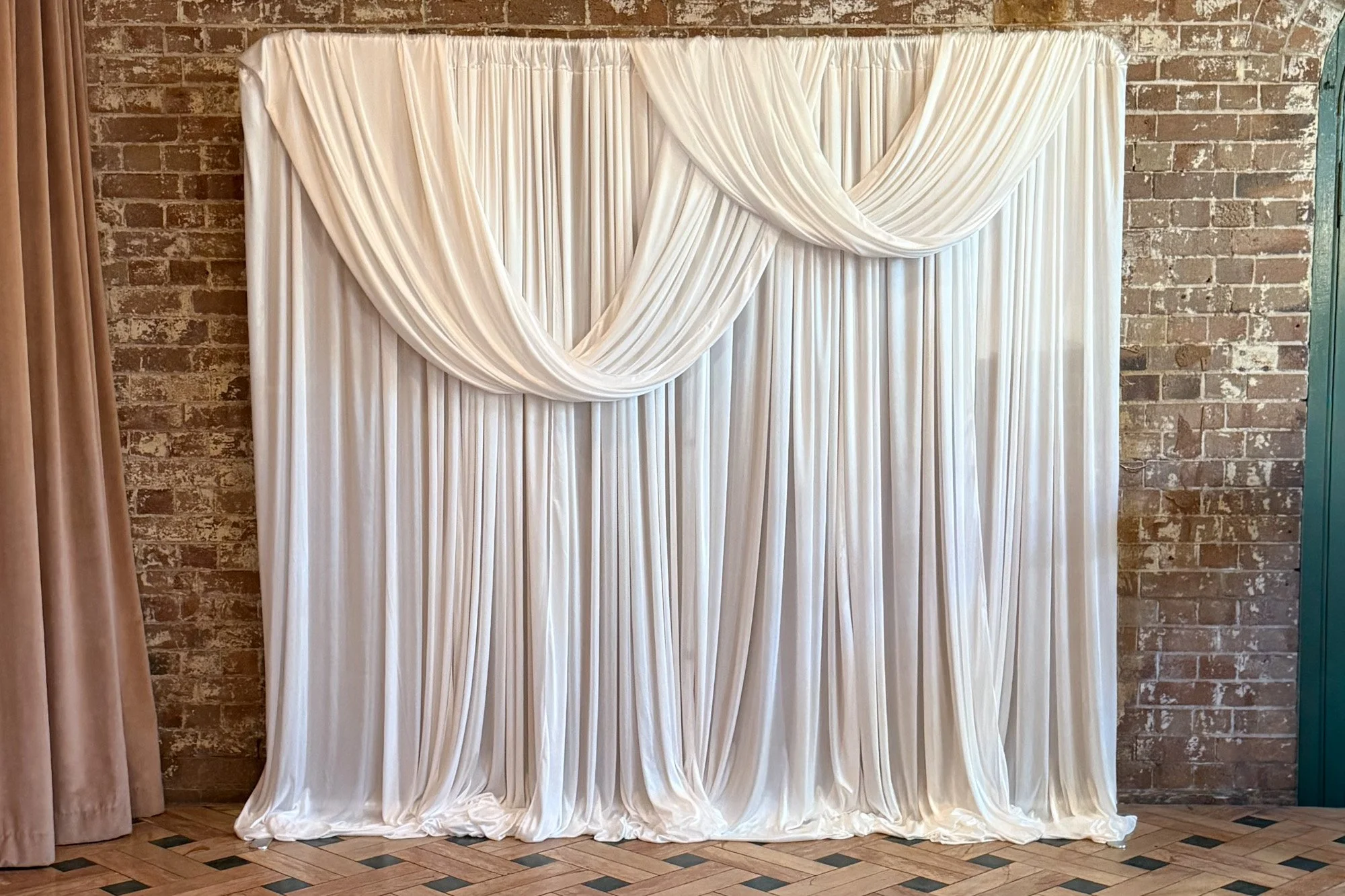 Layered ivory draping with soft cascading folds creating the Cloud Whisper luxe photo booth backdrop.